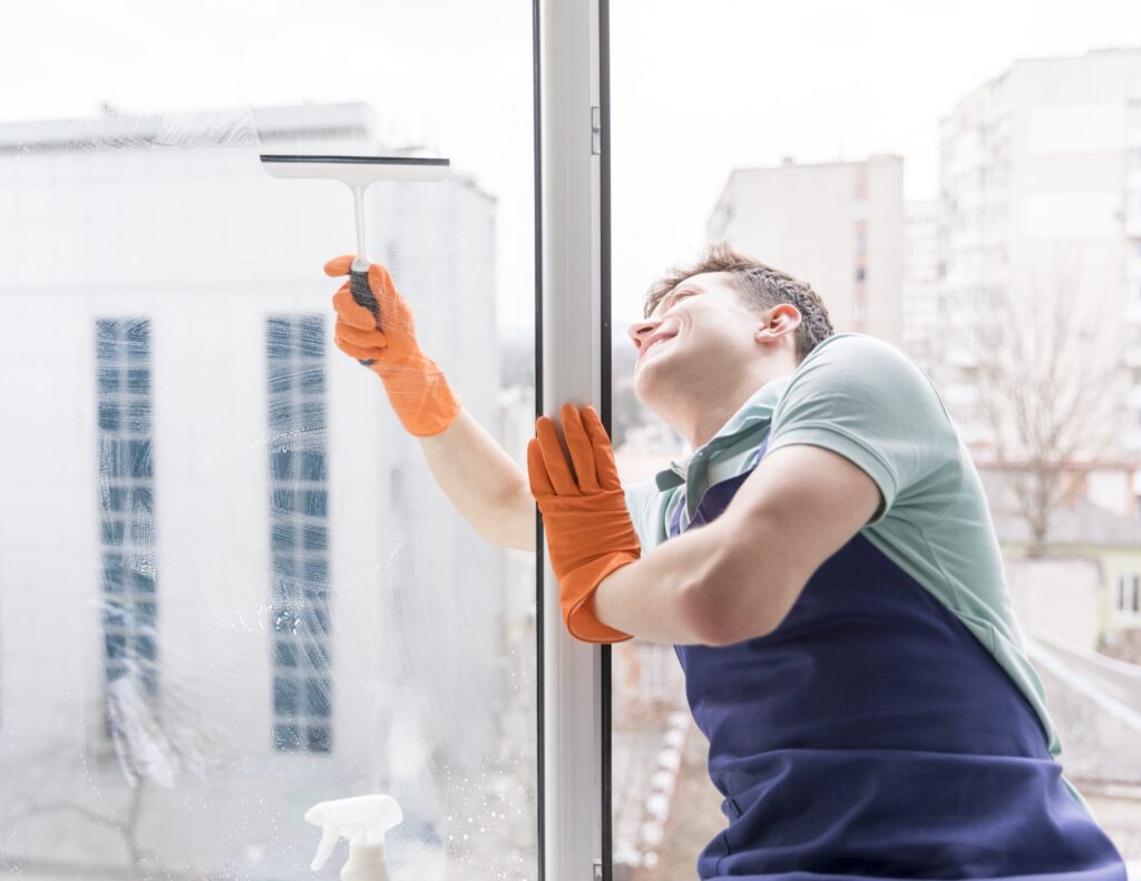 man-cleaning-windows-min